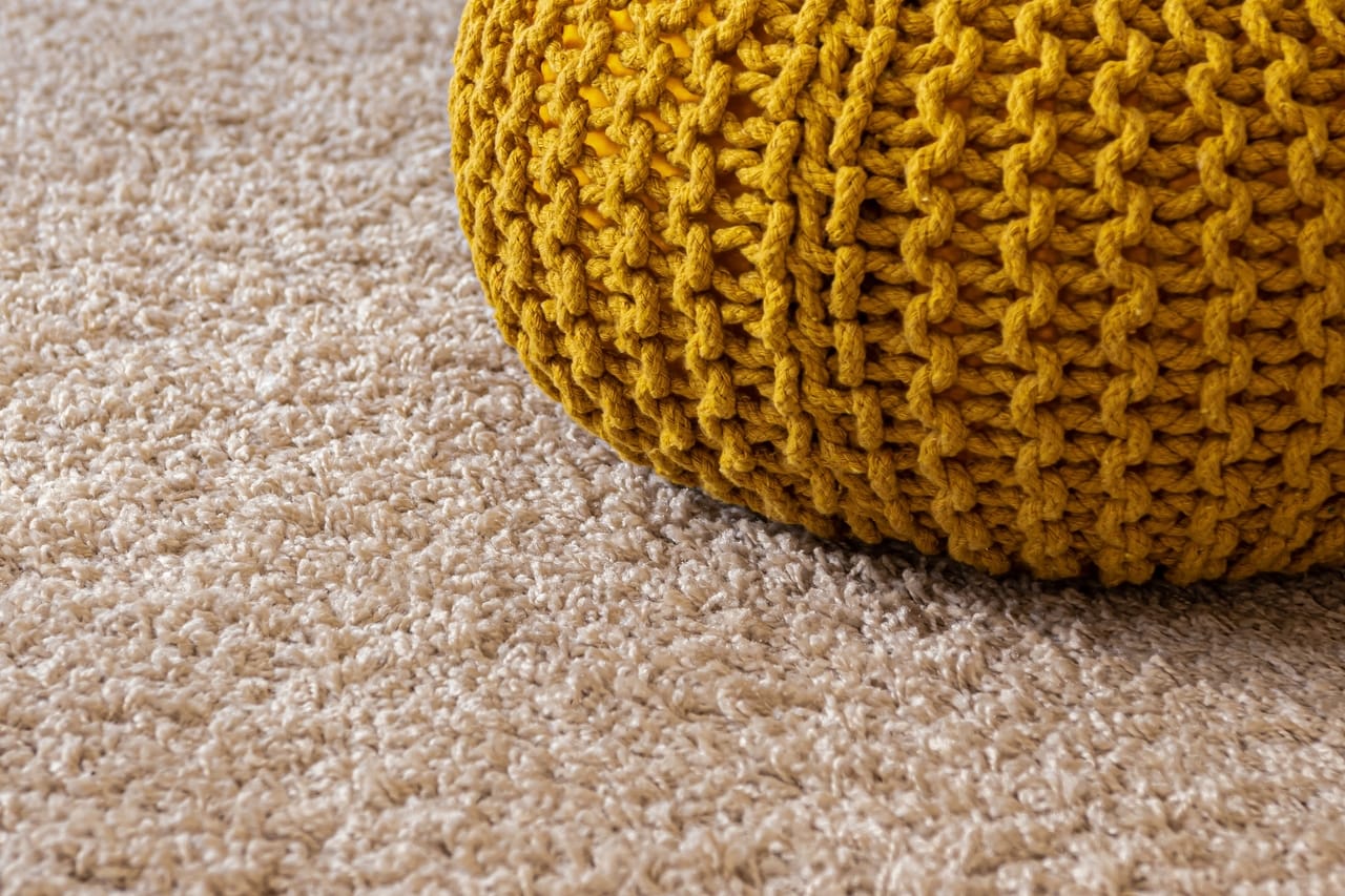 Yellow knitted bag on carpet