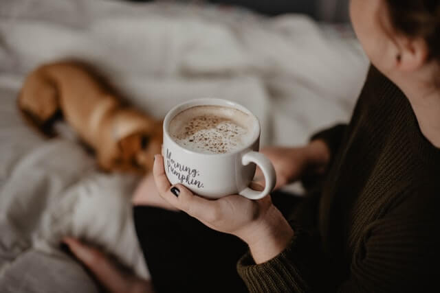 woman-drinking-morning-coffee-with-her-pet